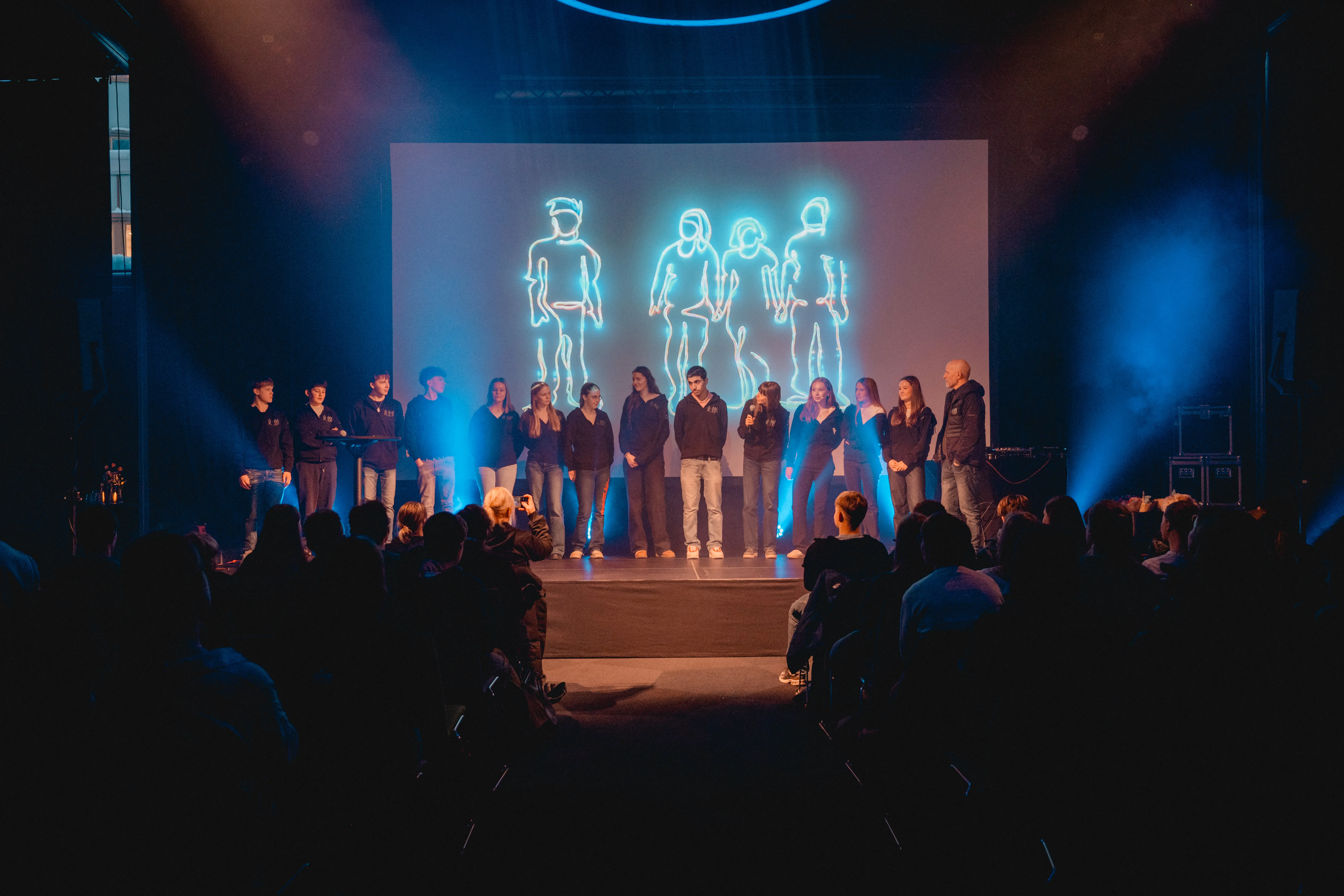 Bilde av 14 ungdommer på scenen under konferanse om utenforskap.