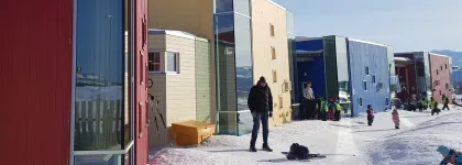 Storvollen barnehages uteområde sett utenfra en vinterdag med snø og blå himmel